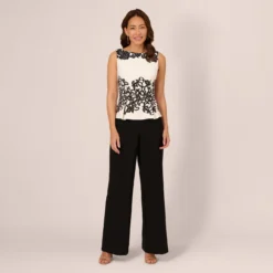Adrianna Papell Sleeveless Peplum Jumpsuit With Scroll Lace Details In Ivory Black